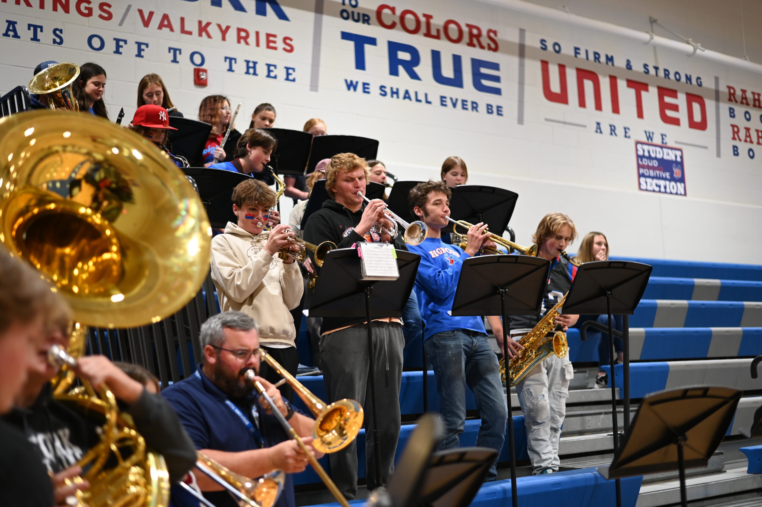 High school band playing at homecoming assembly in gym