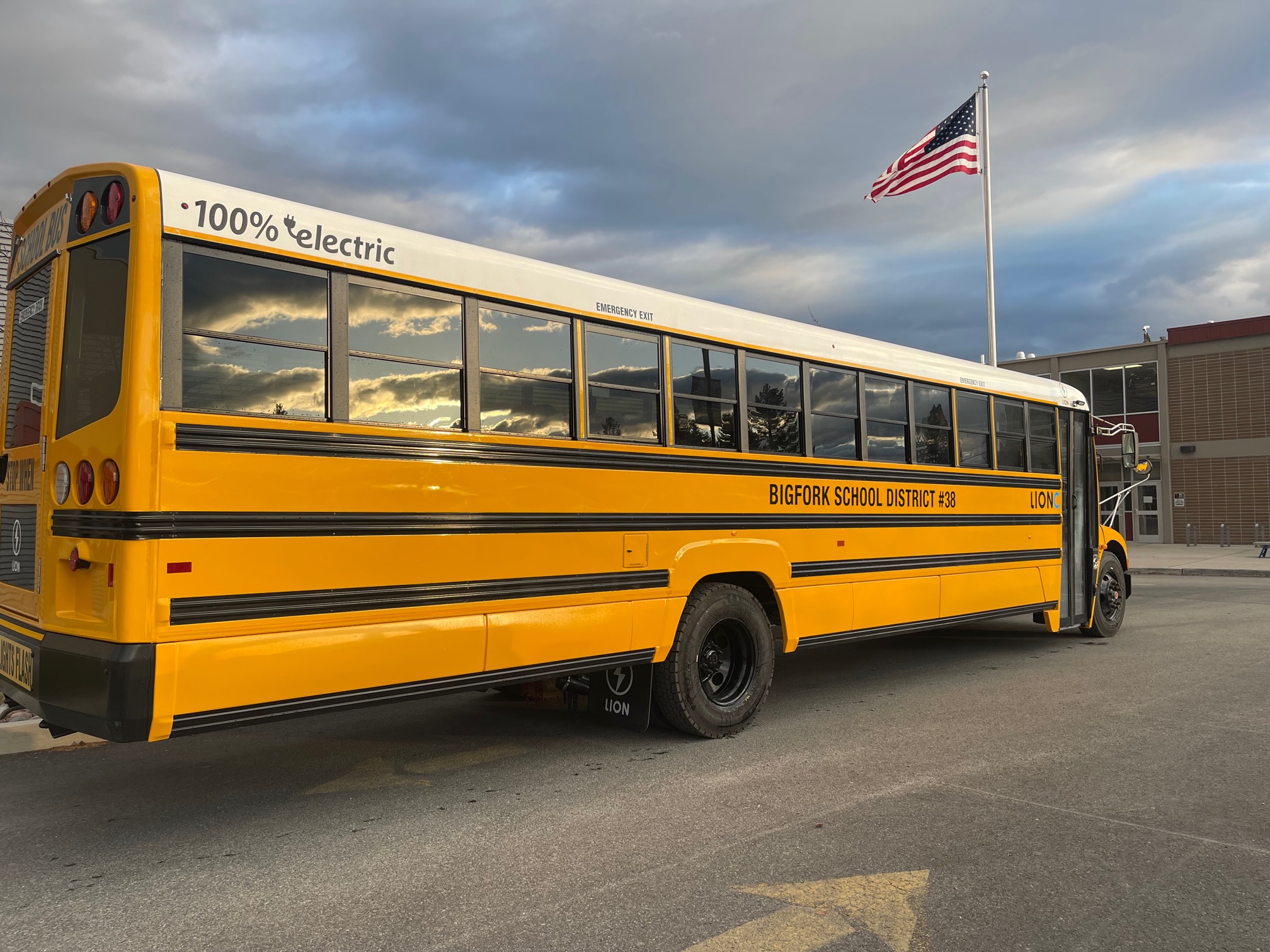 Bigfork Schools electric school bus parked in front of Bigfork high school
