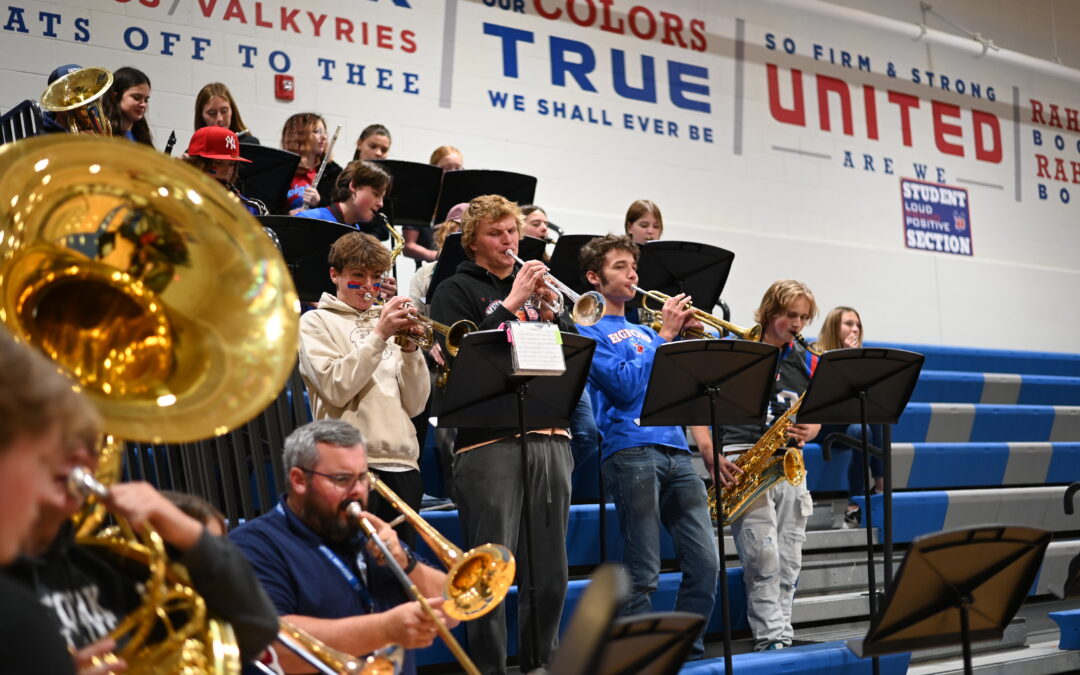 High school band playing at homecoming assembly in gym
