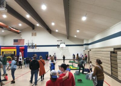Visitors at the Fall Carnival taking part in activities in the school gym