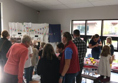 Visitors at the Fall Carnival taking part in activities in the school cafeteria
