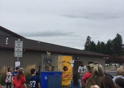 Visitors at the Fall Carnival watch the Dunk Tank activity