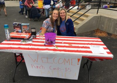 Two of Bigfork School's staff smile for the camera at the entrance of the Fall Carnival