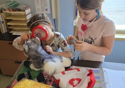 Students caring for the class stuffed dog as part of the IditaREAD challeng.